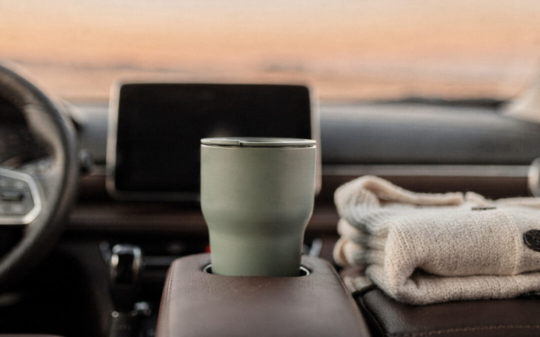 Self-Care When You Have No Time: Decide It Once A sage travel mug in a parked car cup holder beside a folded cream cardigan at golden hour